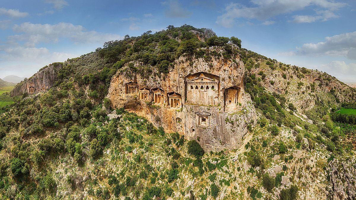 King's Tombs across the turquoise waters of the Dalyan River delta, Türkiye