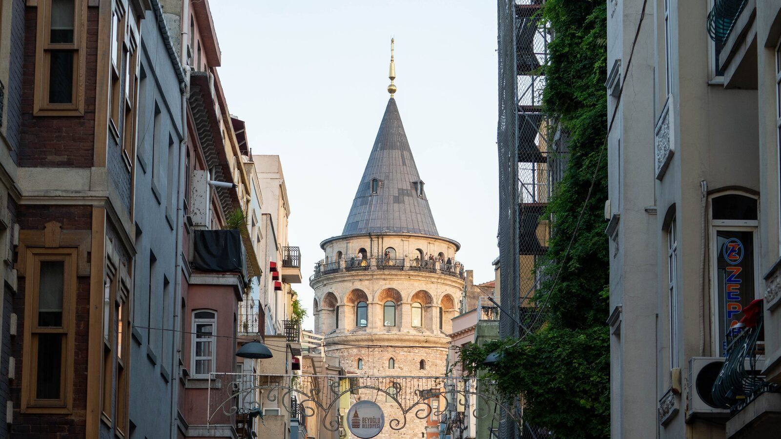 View over Istanbul rooftops towards Galata Tower, hub of a city connected by ferries, trams and metro