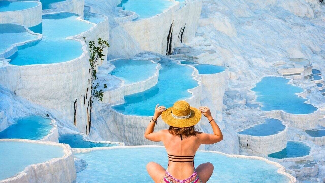 The white travertine thermal terraces of Pamukkale, used for wellness since antiquity
